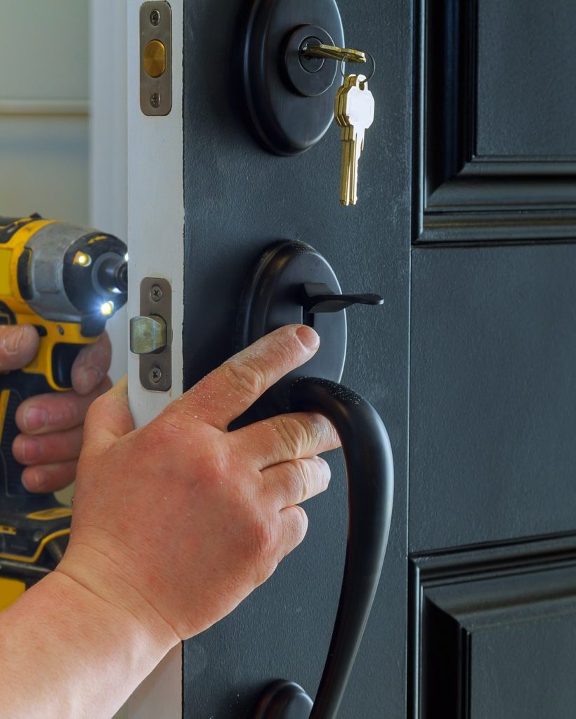 closeup-of-a-professional-locksmith-installing-a-new-lock-on-a-house-exterior-door-with-the-inside.jpg